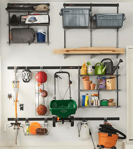 A garage with a variety of items hanging on the wall, featuring custom closet design and organization systems.