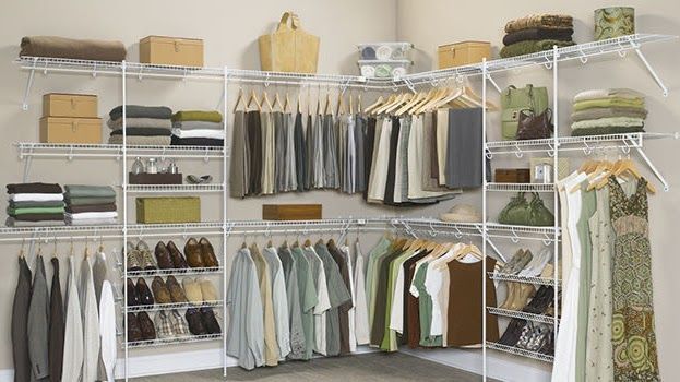 A closet with a lot of clothes and shoes that could benefit from organization systems.