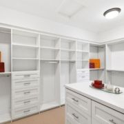 A custom walk in closet with drawers, shelves, and organization systems.