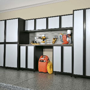 A garage with black and white cabinets and organization systems.