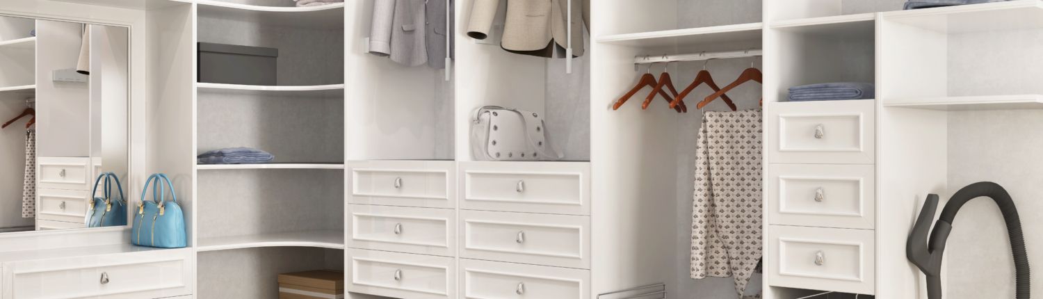 A walk-in closet with a custom closet design and plenty of storage space.
