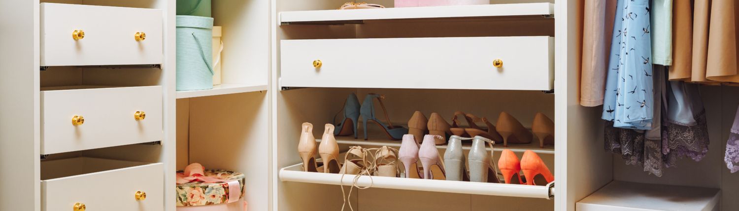 A Custom Closet Design full of clothes and shoes.